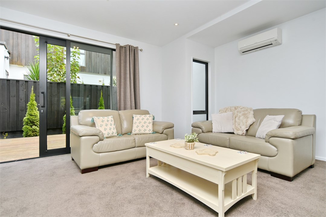 Living room has a TV and seating areas