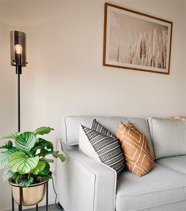 Living room has a TV and seating areas