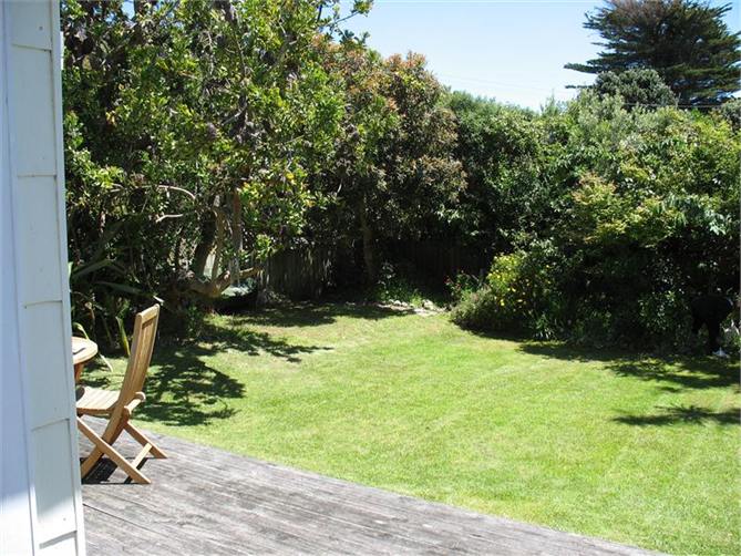 View from deck of lawn and fenced garden