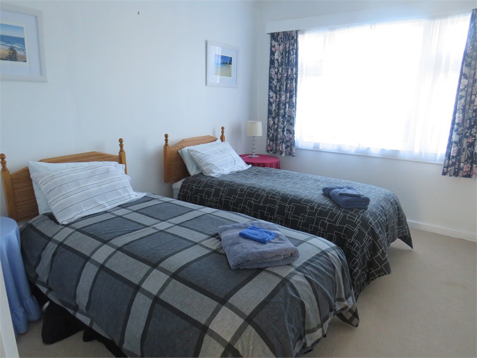 Bedroom 2 with 2 single beds, hanging space and sh