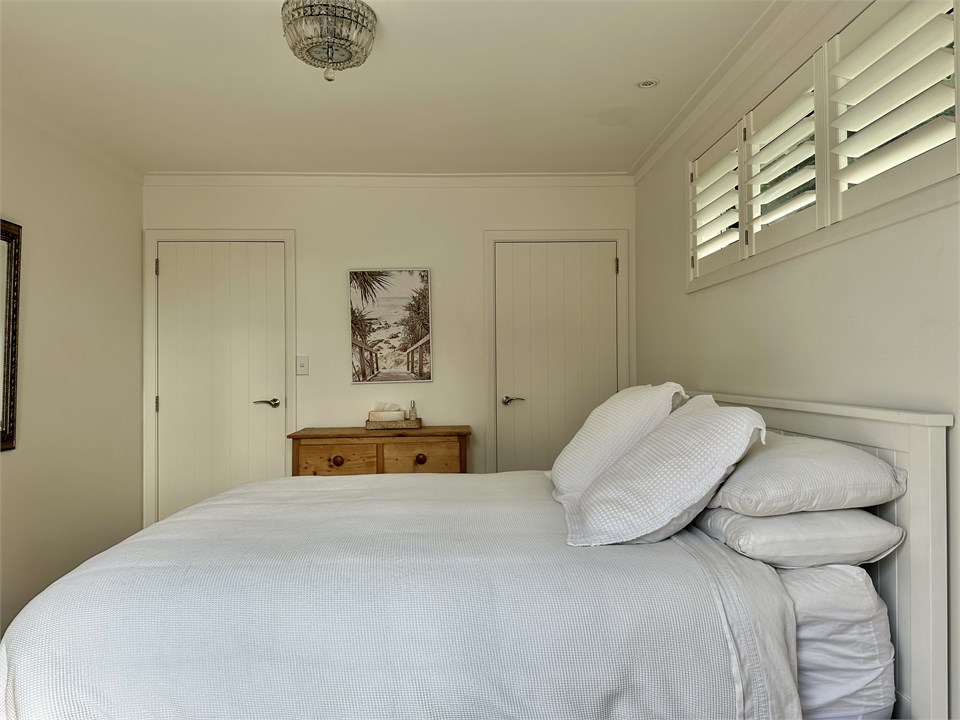 The main bedroom; a queen sized bed.