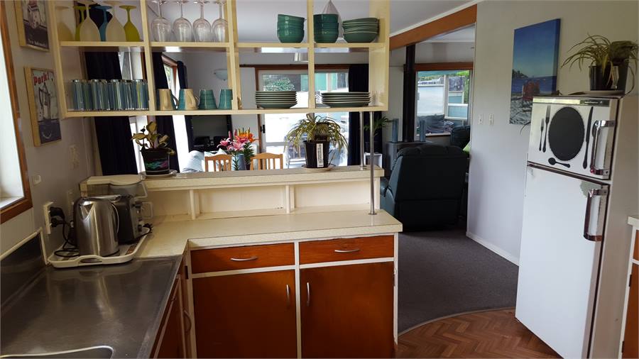 Looking from the kitchen into the dining area and 