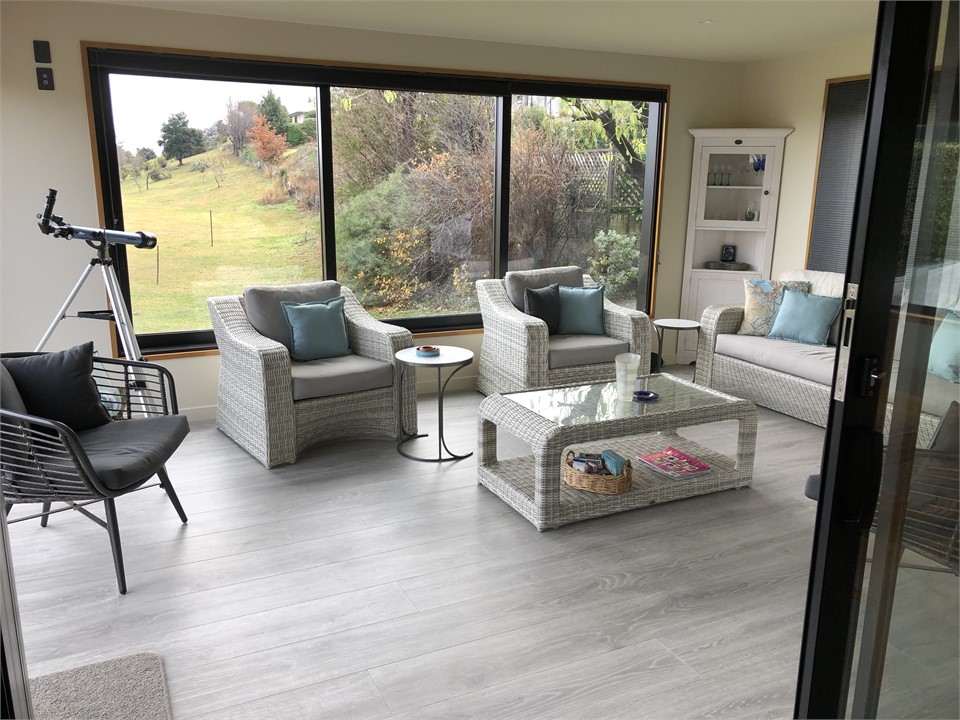 living room opens into sunroom and the  outdoors