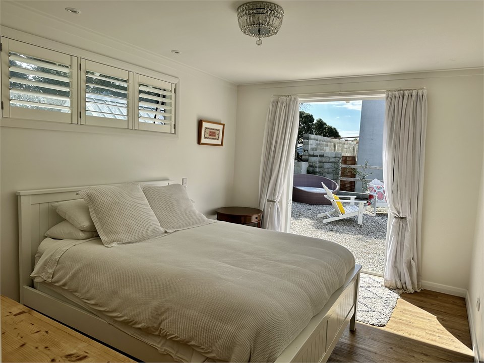 The main bedroom; a queen sized bed.