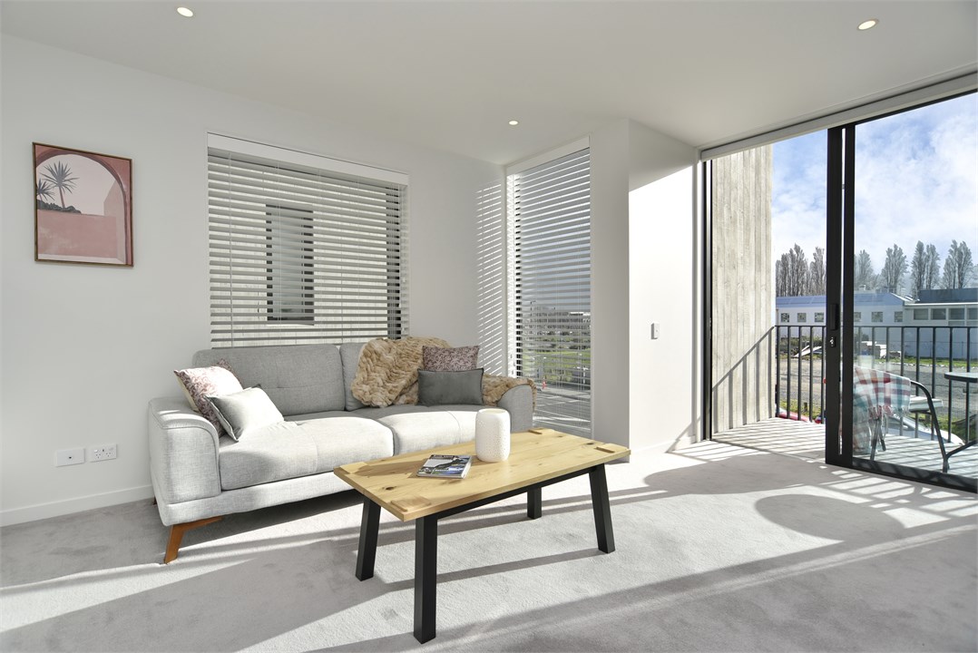 Living room has a TV and seating areas