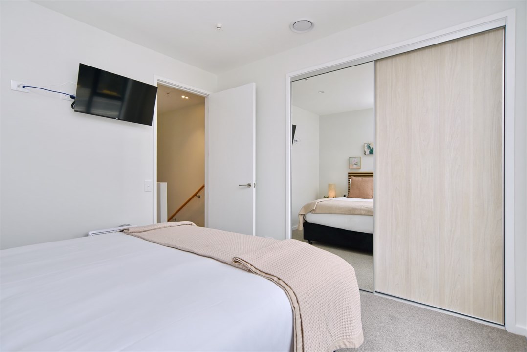 Bedroom 2 has a Queen bed and a TV