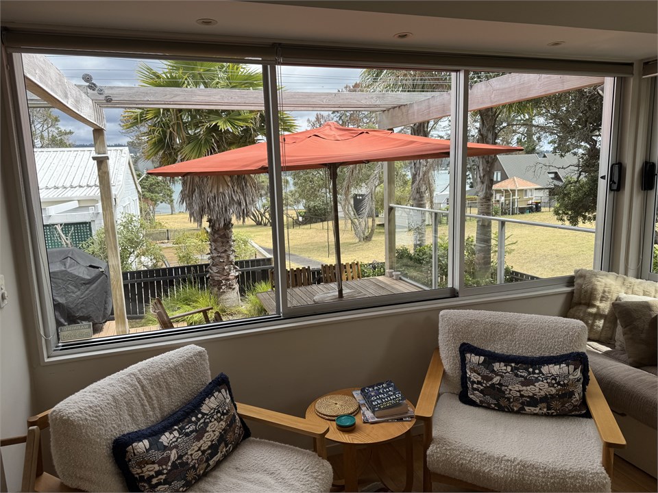 Sitting room looking out to deck and estuary
