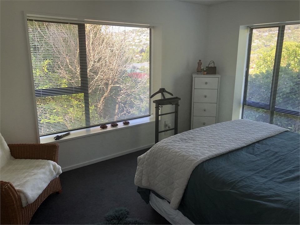 Master bedroom with sun and bush views