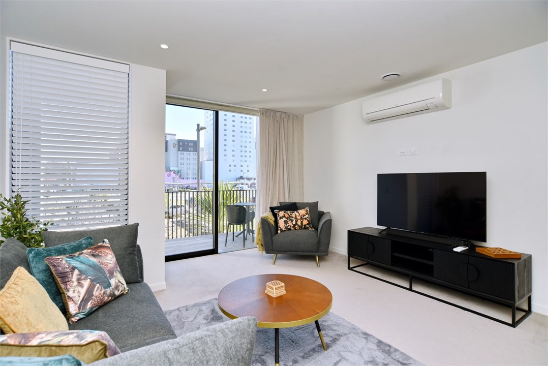 Living room has a TV and seating areas