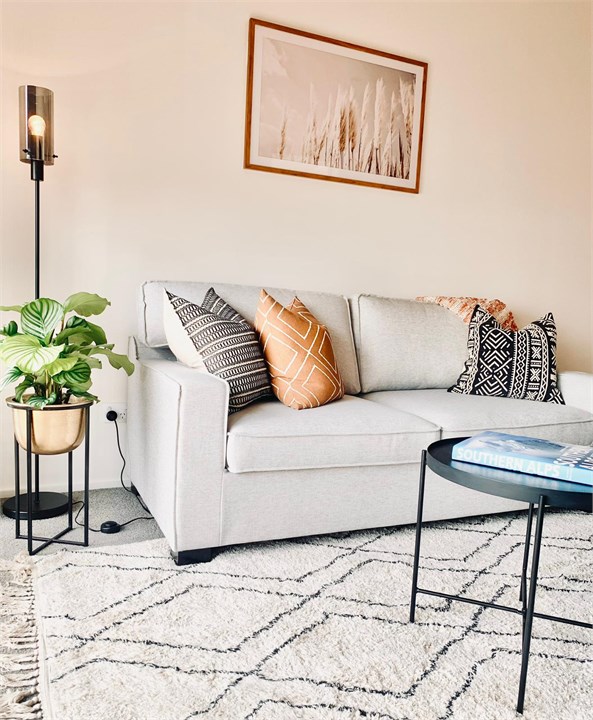 Living room has a TV and seating areas