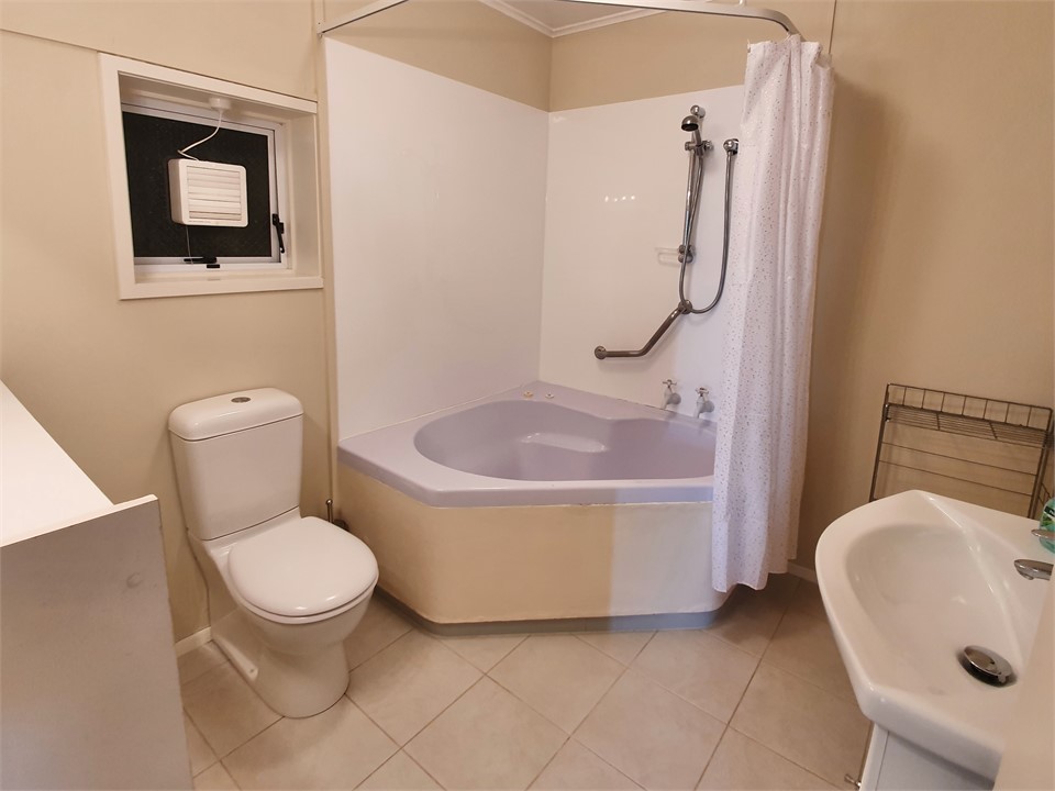 Bathroom with Shower over Bath, Toilet & Vanity