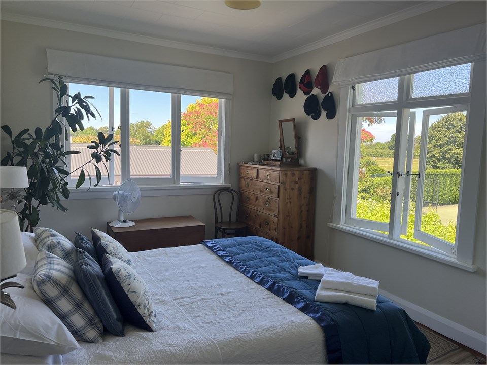 Upstairs queen bedroom with views over garden to T