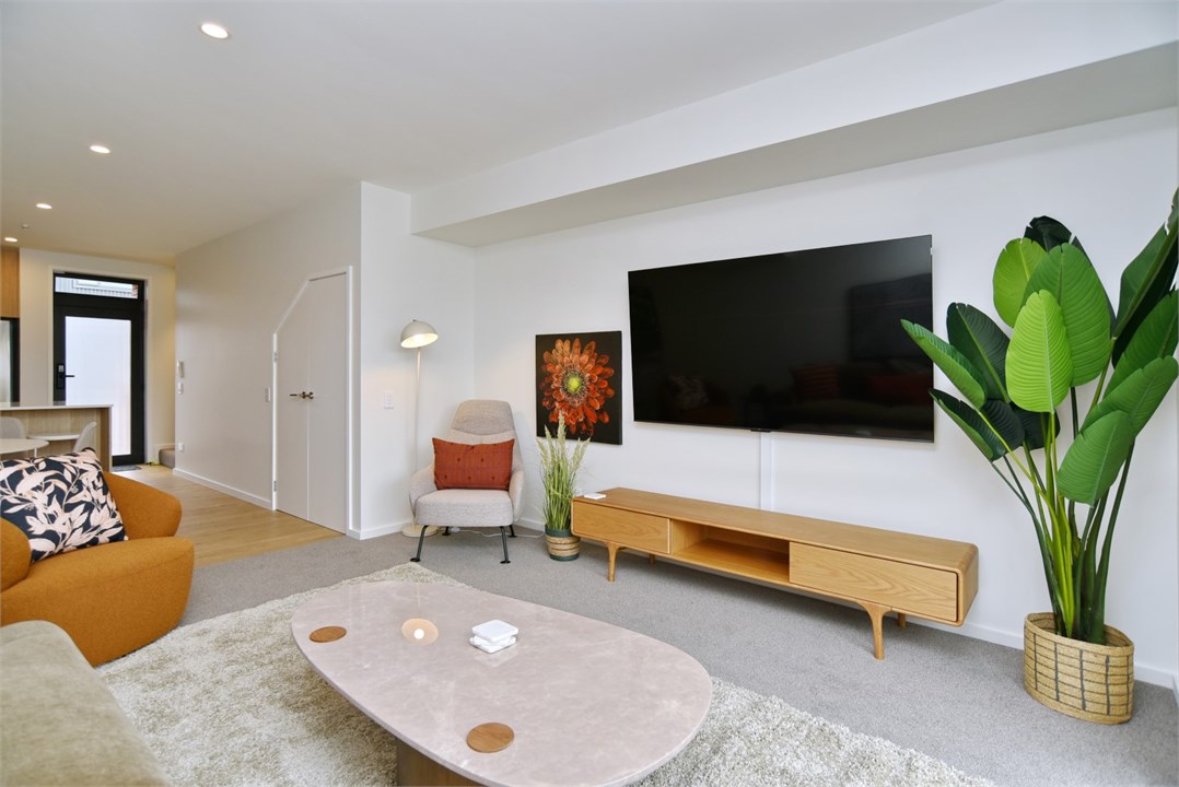 Living room has a TV and seating areas
