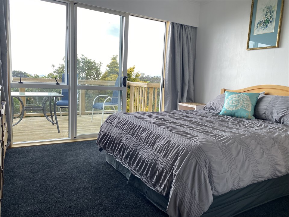 Main bedroom with deck access and sea views