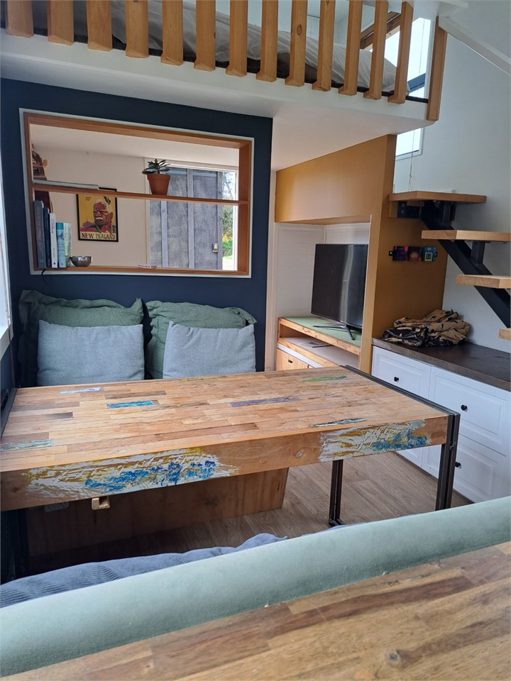 Bright indoor dining area with bush views