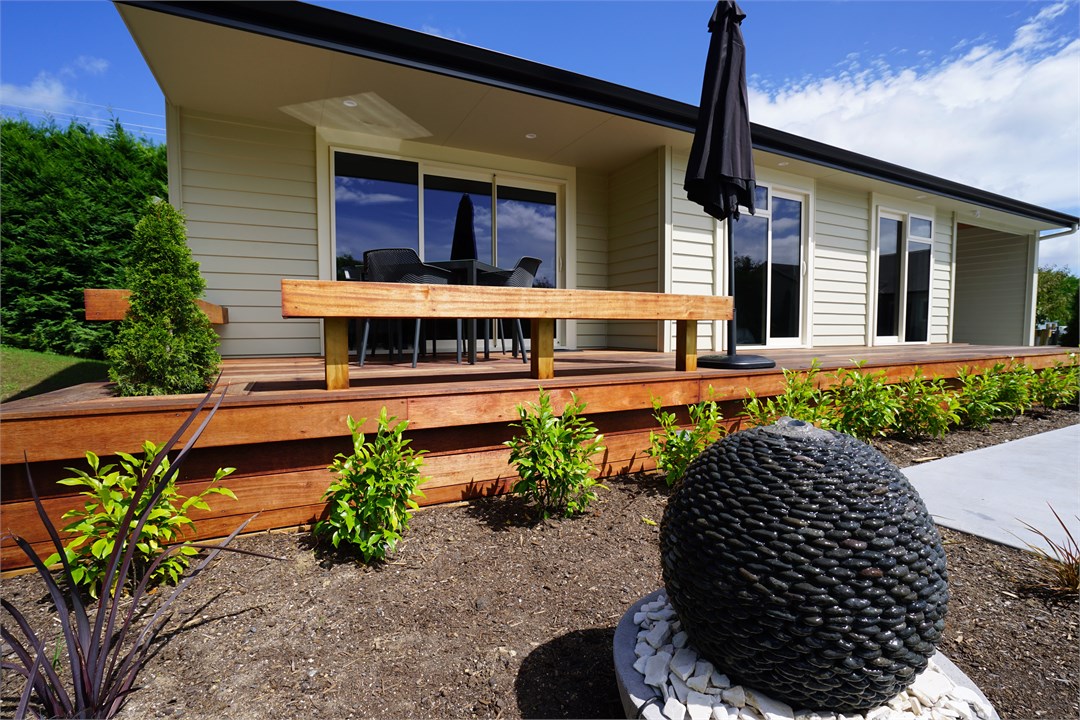 View of the property building and front deck