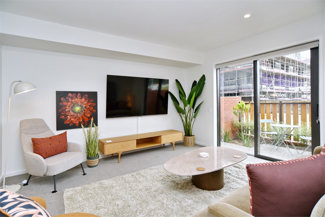 Living room has a TV and seating areas
