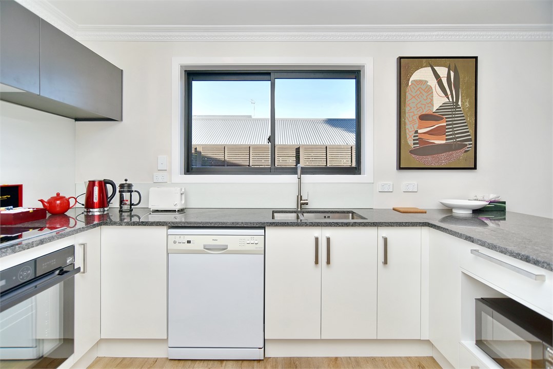 Full kitchen with a sitting area at the bench