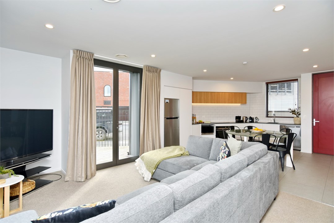 Living room has seating areas and a TV