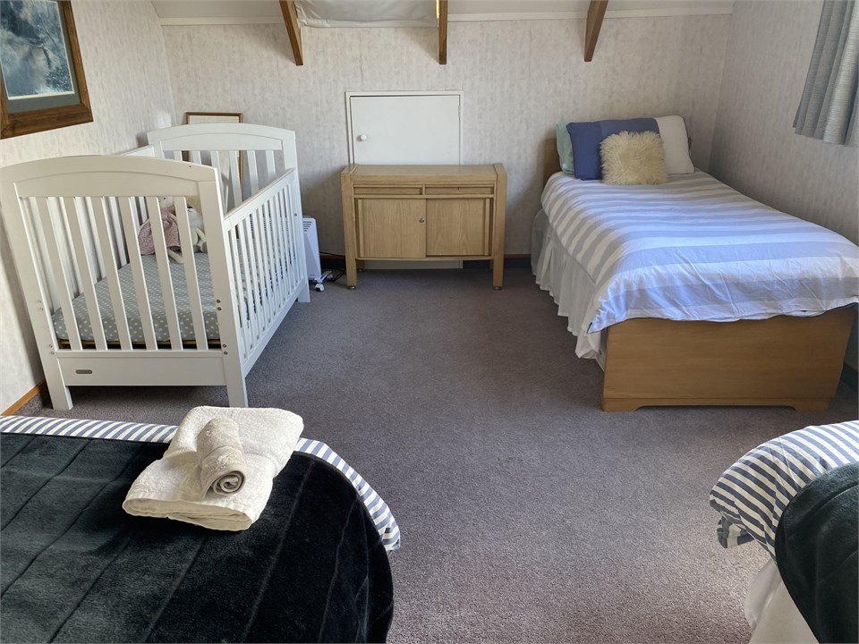 Upstairs 3 single beds plus cot