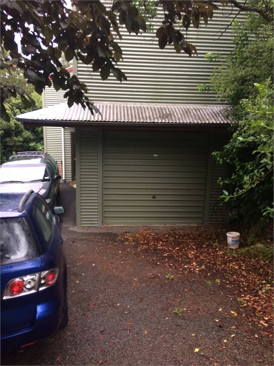 House from driveway, lockbox next to front door