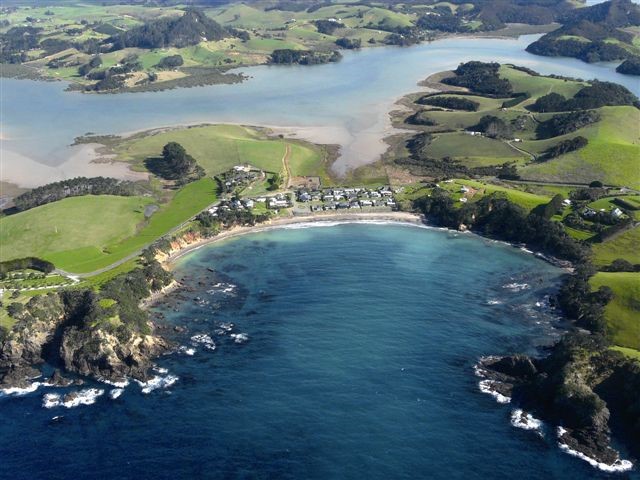 House is on a hillside overlooking Pacific Ocean a