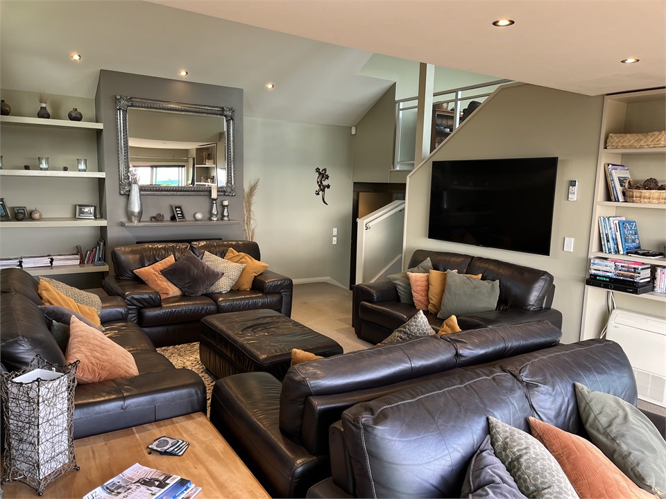 Living room: seats 12+ on 5 sofas. 65" smart TV