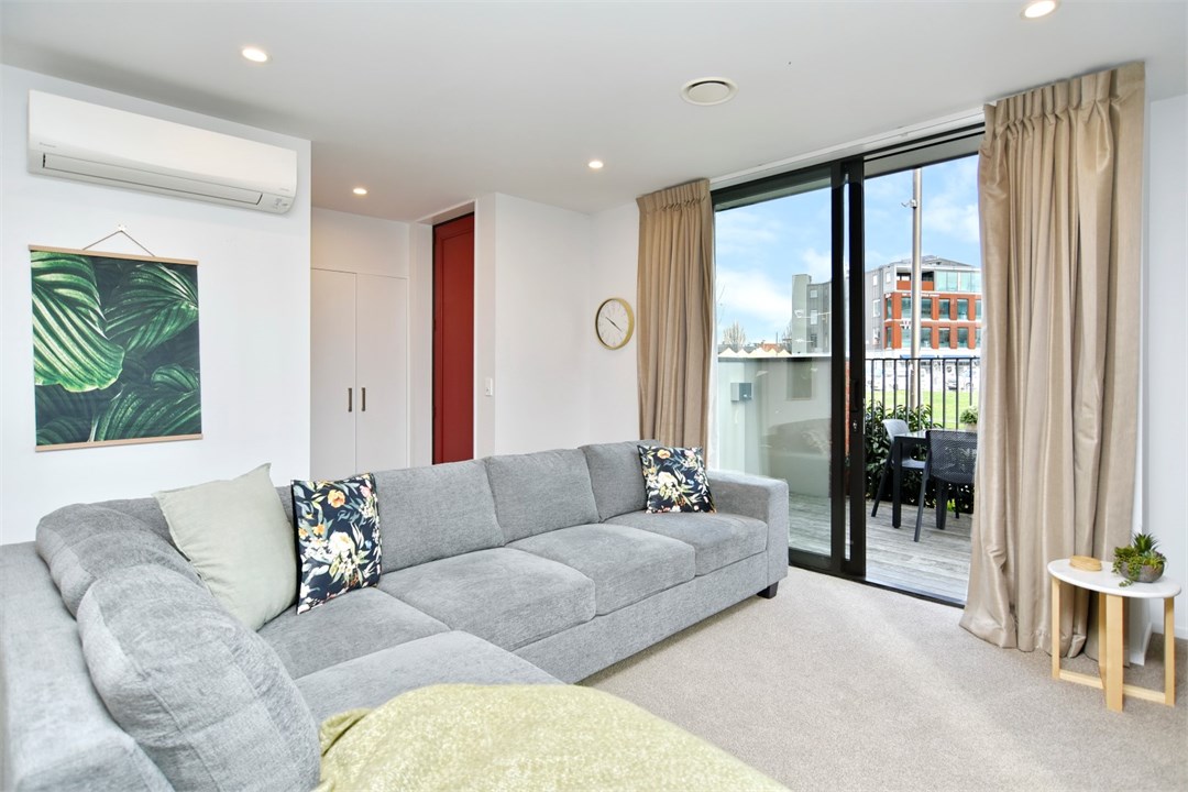 Living room has seating areas and a TV