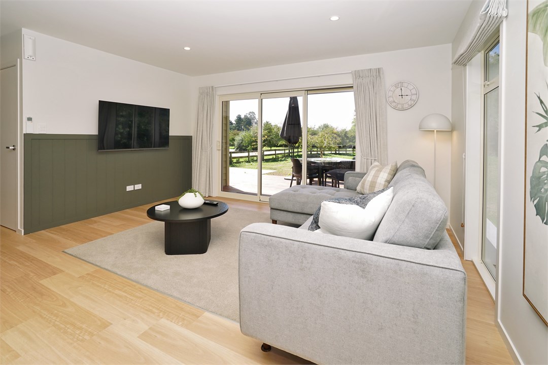 Living room has a TV and seating areas