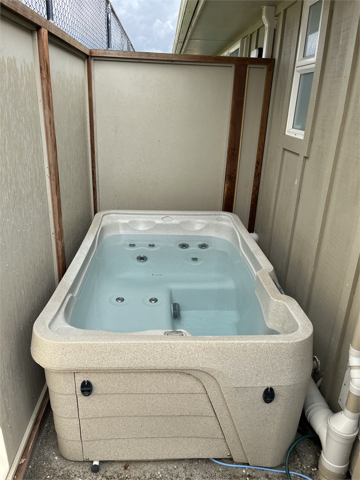 2-person spa pool in private enclosure.