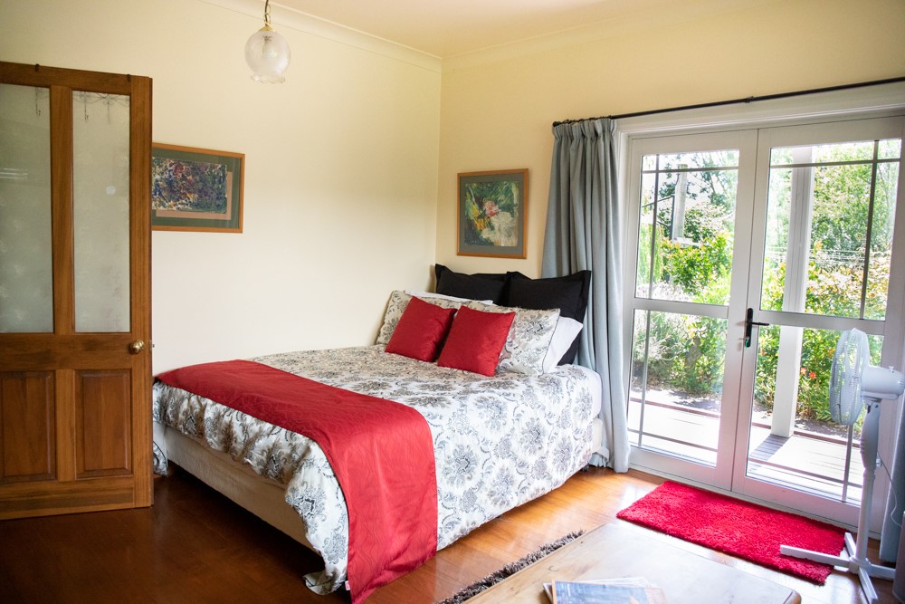 TV room with queen bed