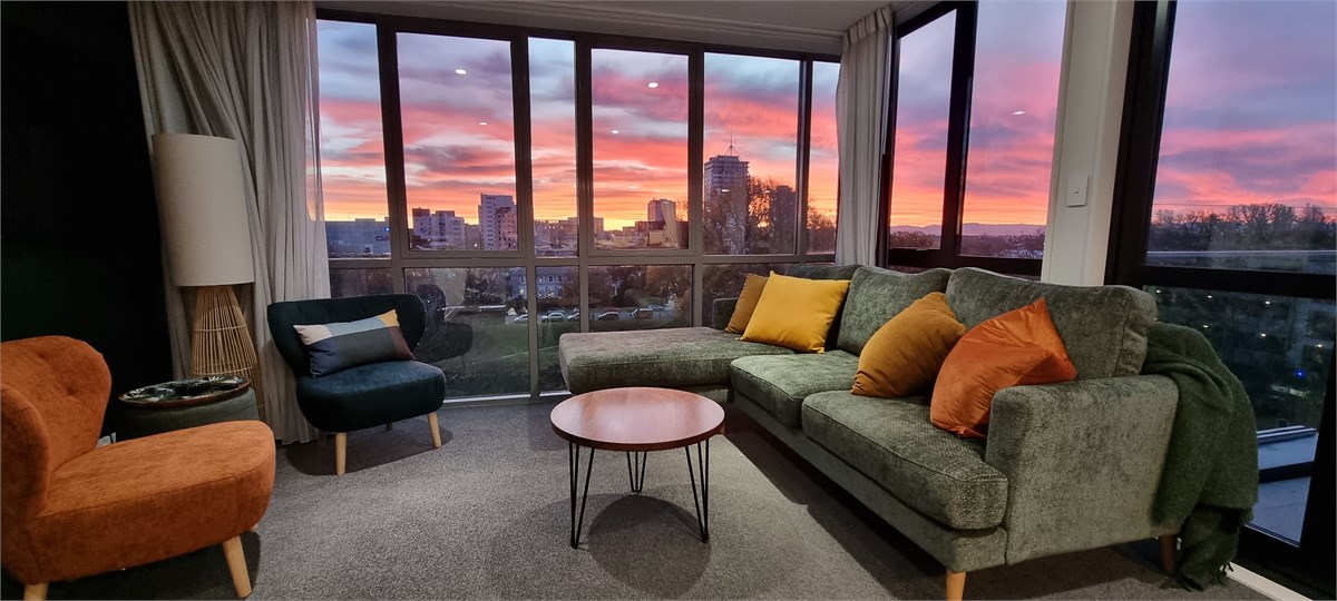 Living room has a seating area and a TV