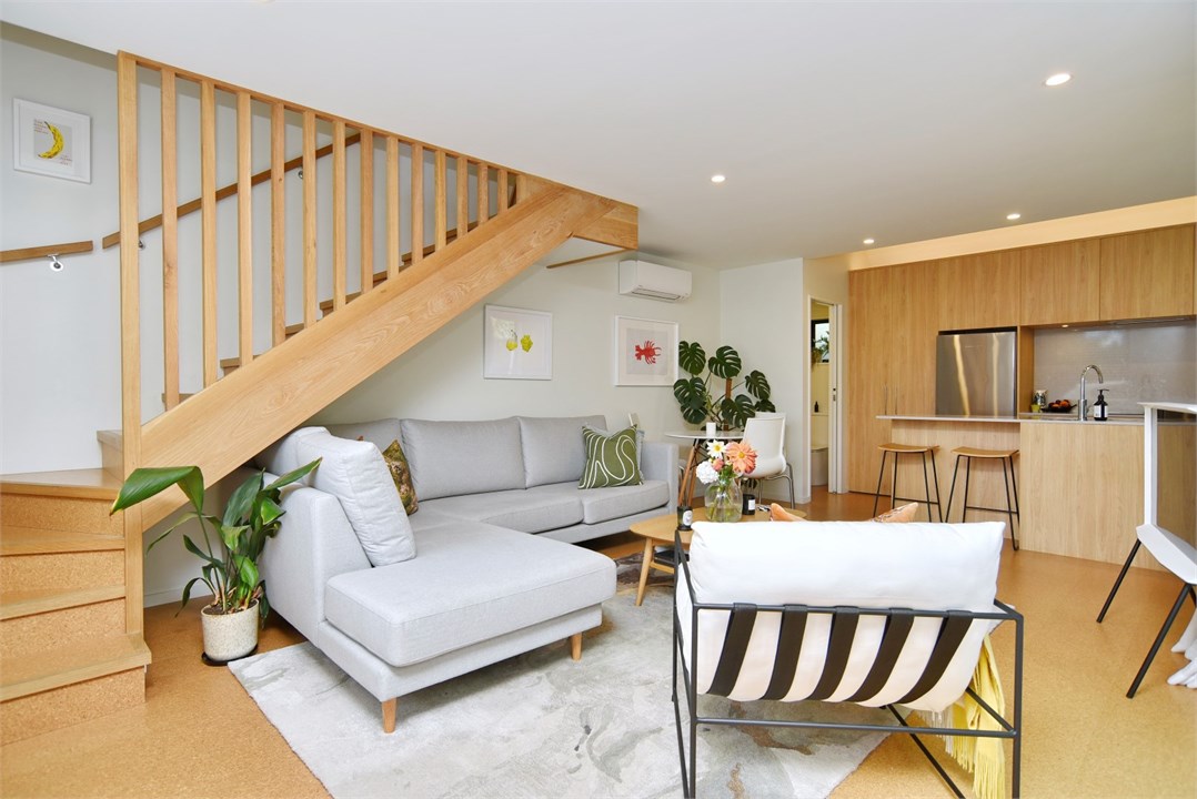 Living room with seating areas and a TV