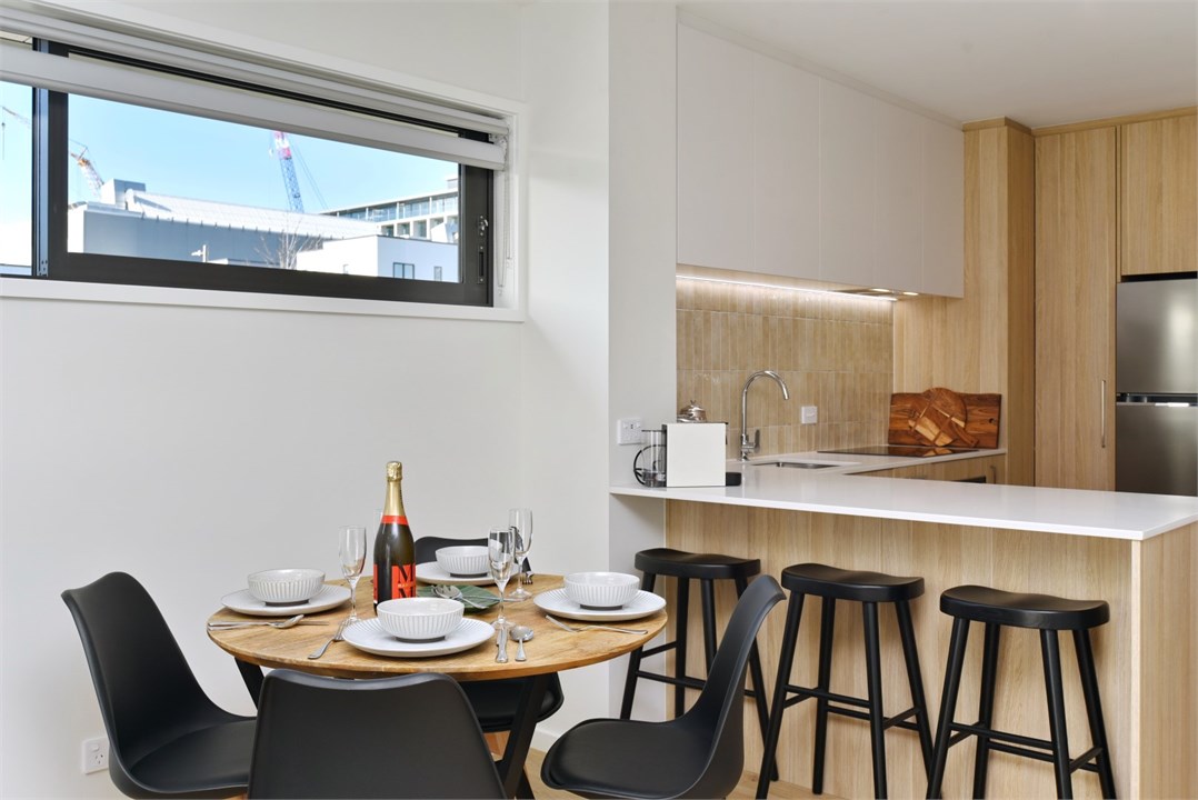 View of the dining table and kitchen seating area