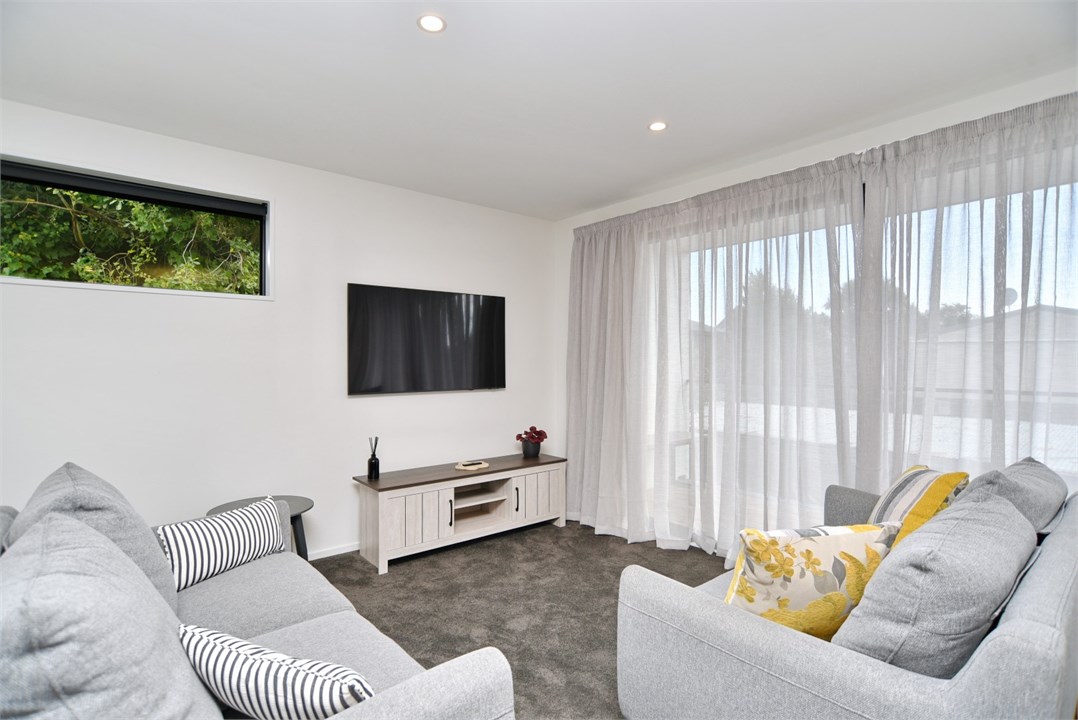 Living room has a TV and seating areas