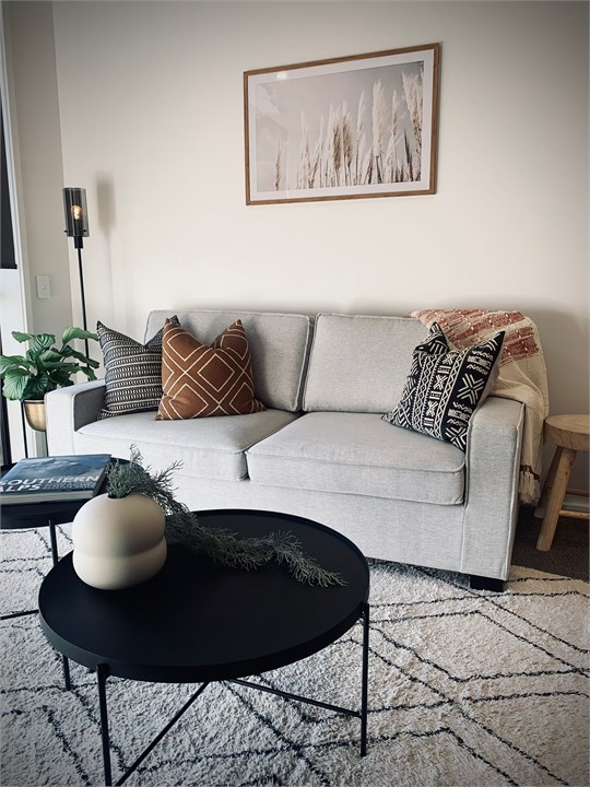 Living room has a TV and seating areas