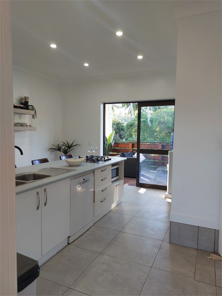 Kitchen out to the balcony area with outdoor furni