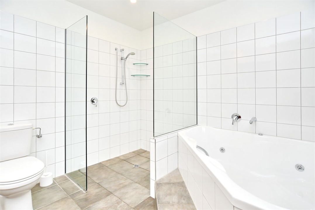 En suite to Bedroom 1 with a spa bath, shower and 