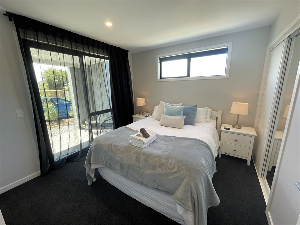 Queen size bedroom with patio on the bottom storey