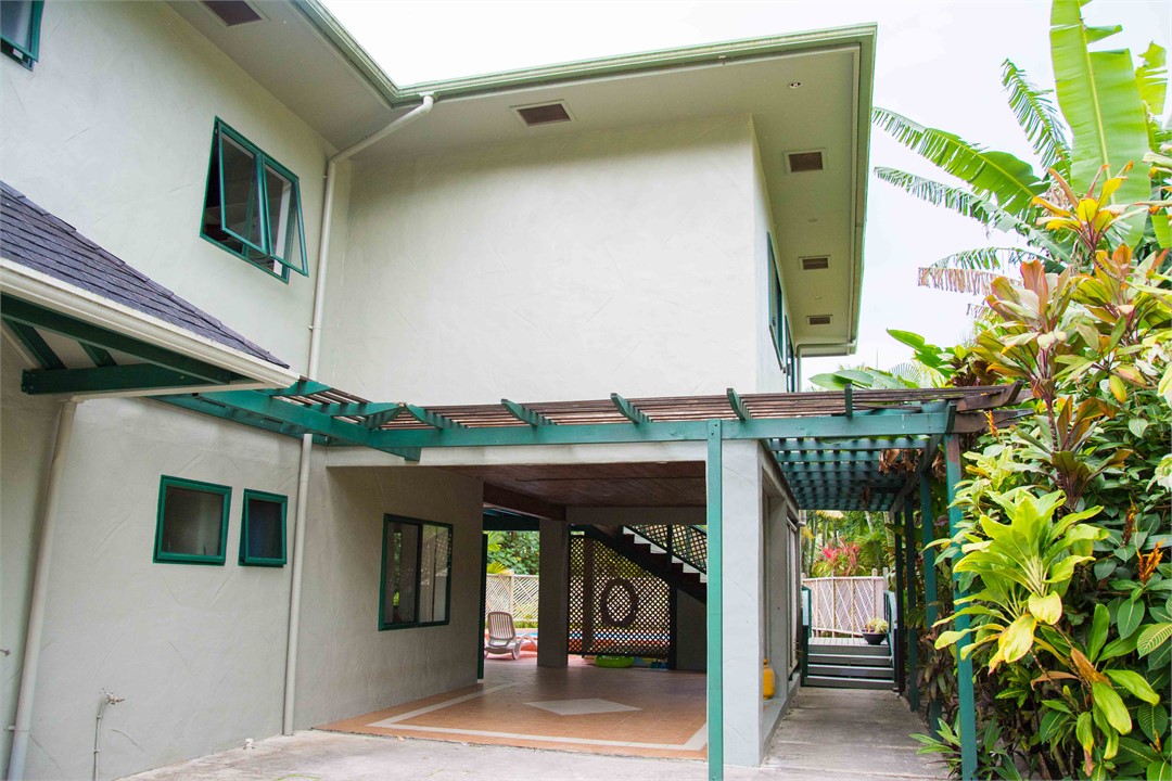 Driveway entrance view with 2 u/c carport