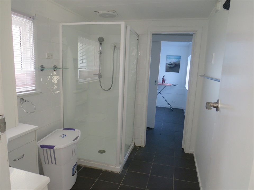 Bathroom with vanity, shower and toilet
