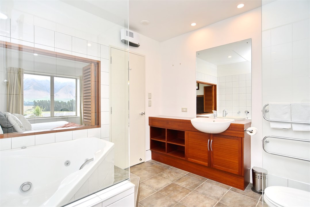 En suite to Bedroom 1 with a spa bath, shower and 