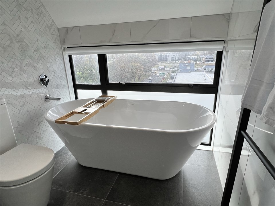 Bathroom 1 has a bathtub and a toilet