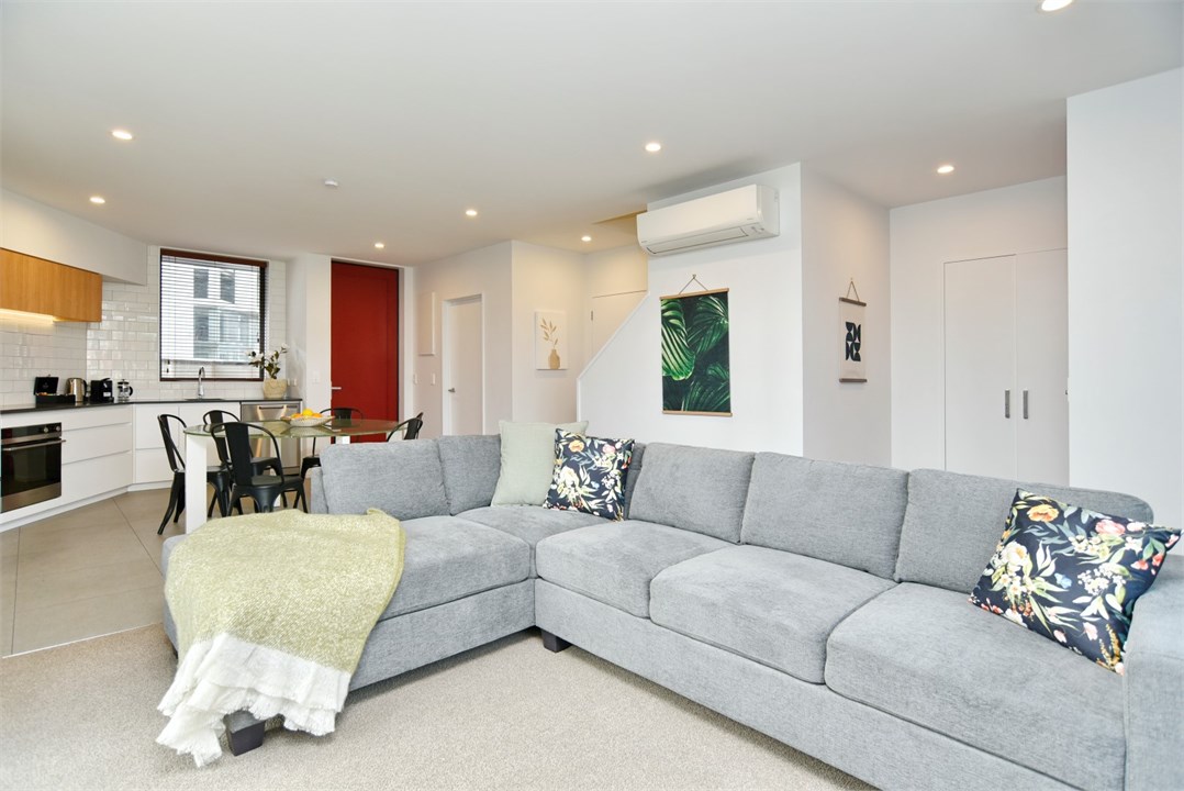 Living room has seating areas and a TV