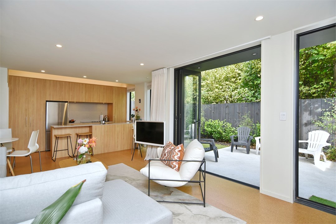 Living room with seating areas and a TV