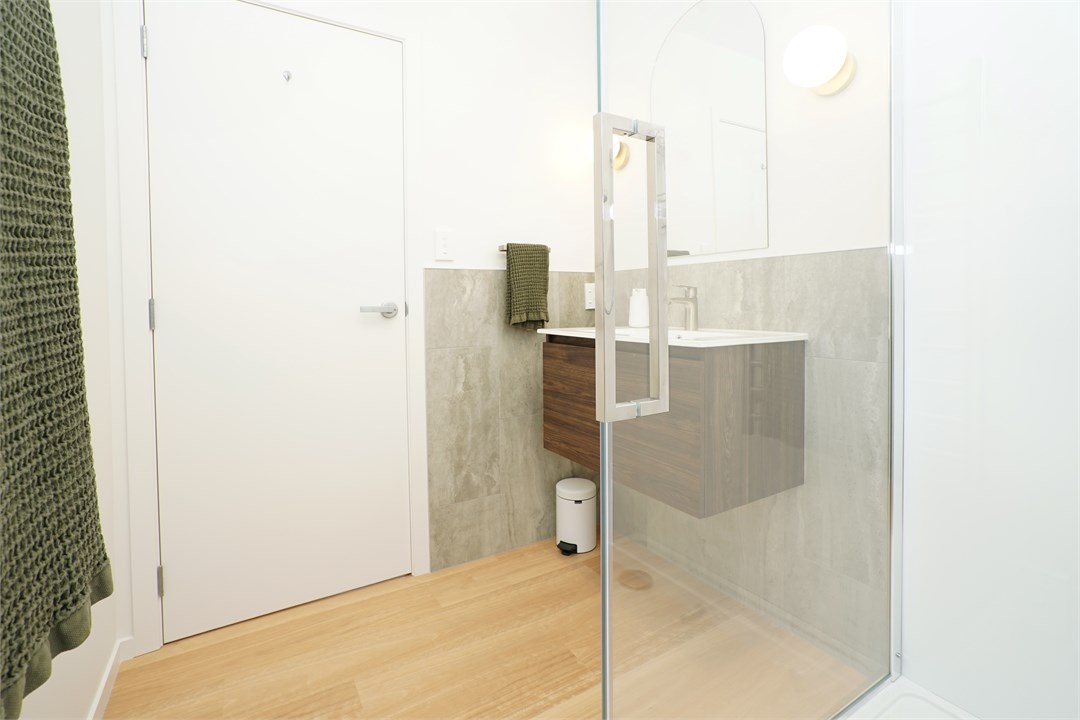 Bathroom has a shower with toilet in separate area