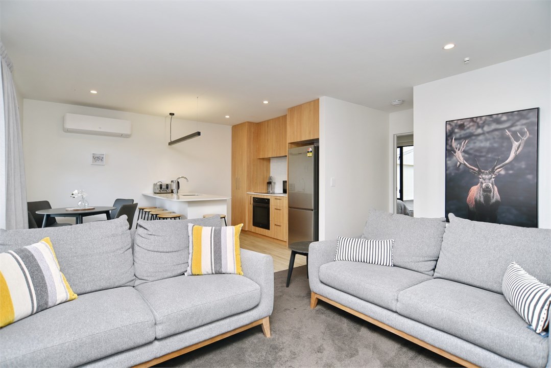 Living room has a TV and seating areas