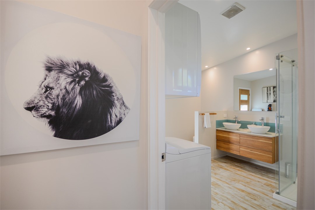 Bathroom has a shower, toilet and laundry area