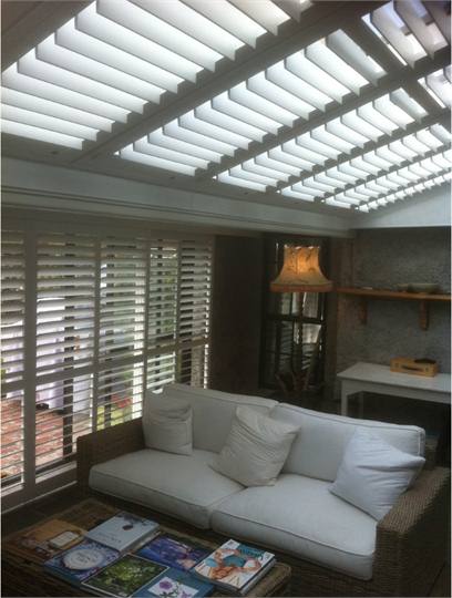 Conservatory with sliding shutters