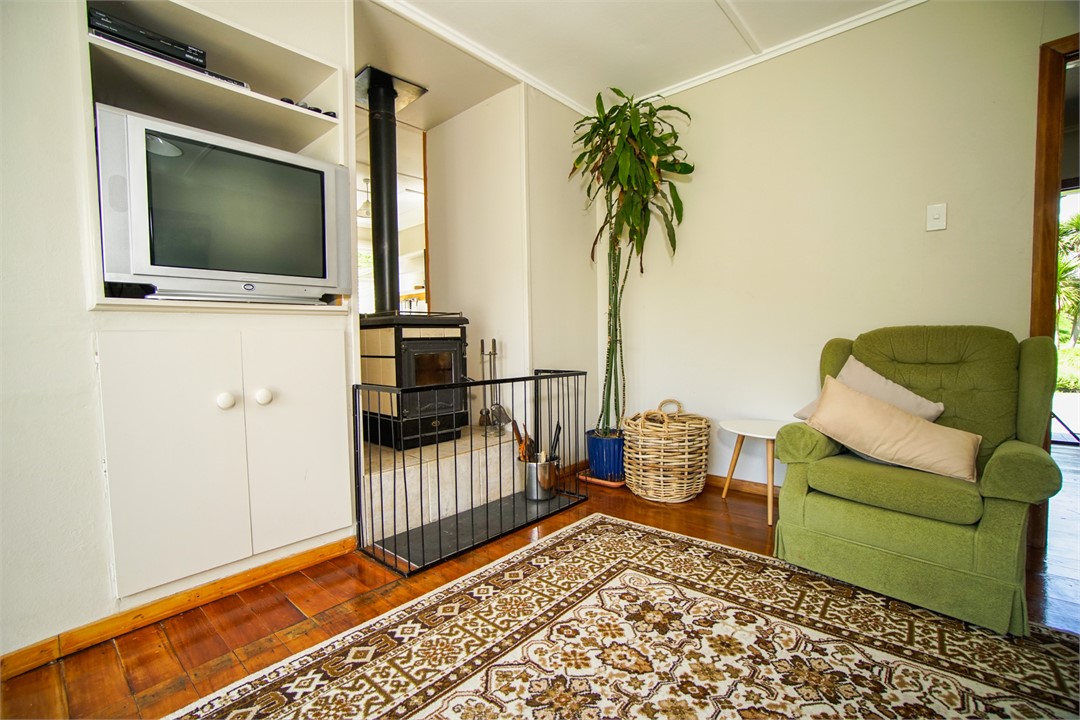 TV Lounge with woodburner and toy cupboard